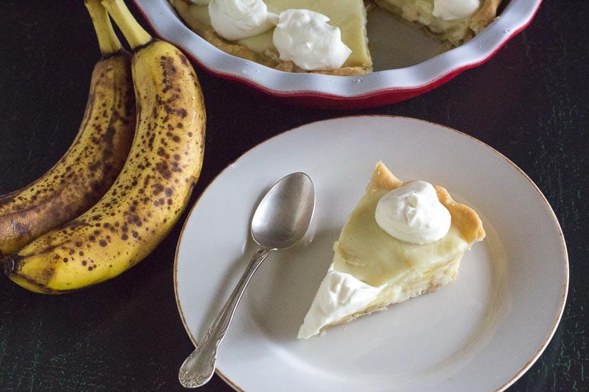 slice of low FODMAP banana cream pie on white plate with spoon
