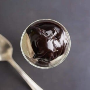 overhead shot of low FODMAP CBD oil hot fudge sauce with spoon alongside_