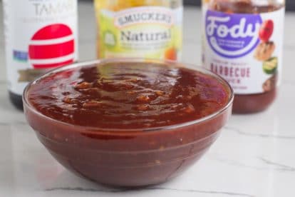 Low FODMAP Orange marmalade BBQ Sauce in glass bowl with ingredients in background