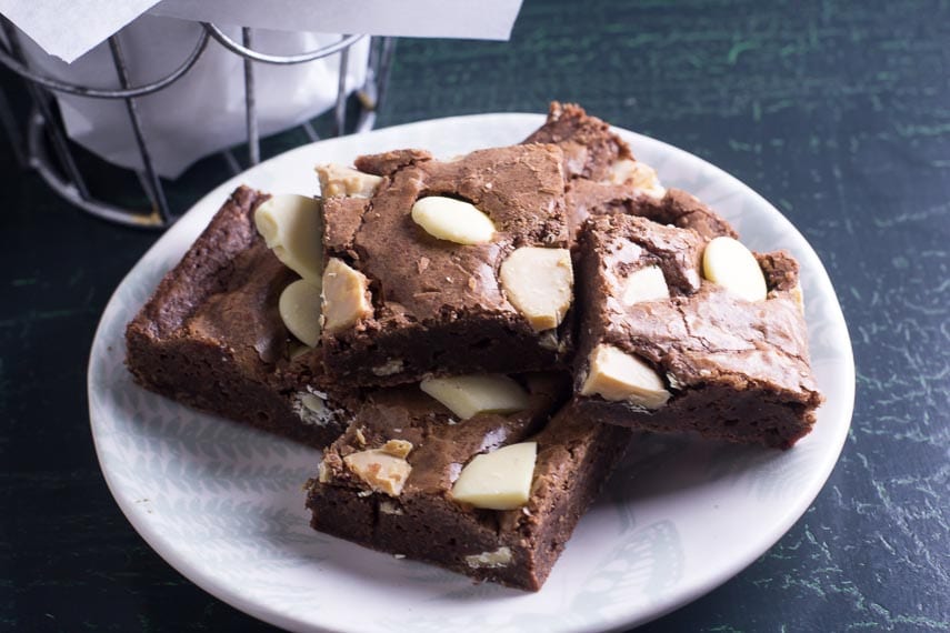 low FODMAP Black & White Brownies on a small plate on a green crackled surface