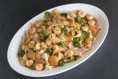 Low FODMAP Hot and Sour Shrimp Lo Mein on white oval platter