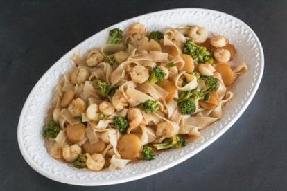 Low FODMAP Hot and Sour Shrimp Lo Mein on white oval platter