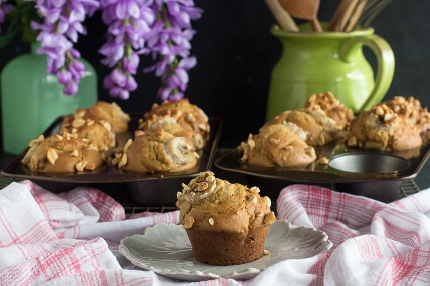 horizontal image of low FODMAP Peanut Butter Banana Muffins; on plate and in muffin pans