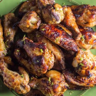 low FODMAP Honey Roasted Chili Lime Chicken wings, closeup, on a green plate