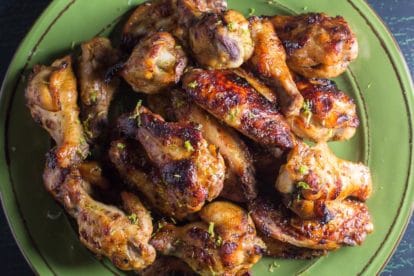 low FODMAP Honey Roasted Chili Lime Chicken wings, closeup, on a green plate