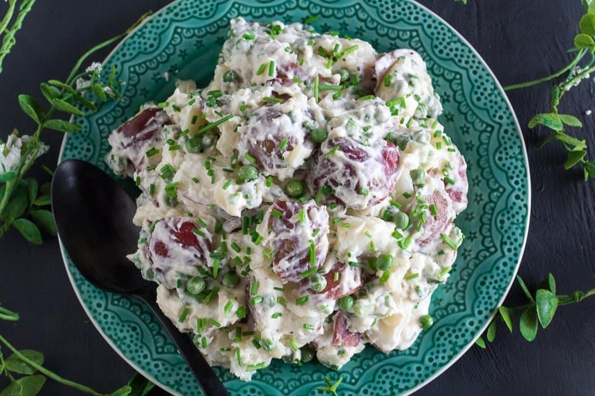 overhead image of FODMAP IT!™ Potato Salad with Peas & Chives on a green plate