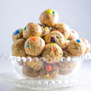closeup side view of low FODMAP Trail Mix Energy Balls in clear glass dish