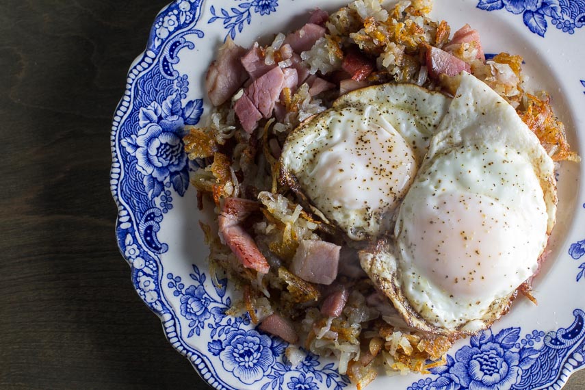overhead image of low fodmap hash browns with ham and eggs