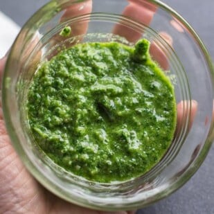 low FODMAP parsley pesto in a clear glass bowl