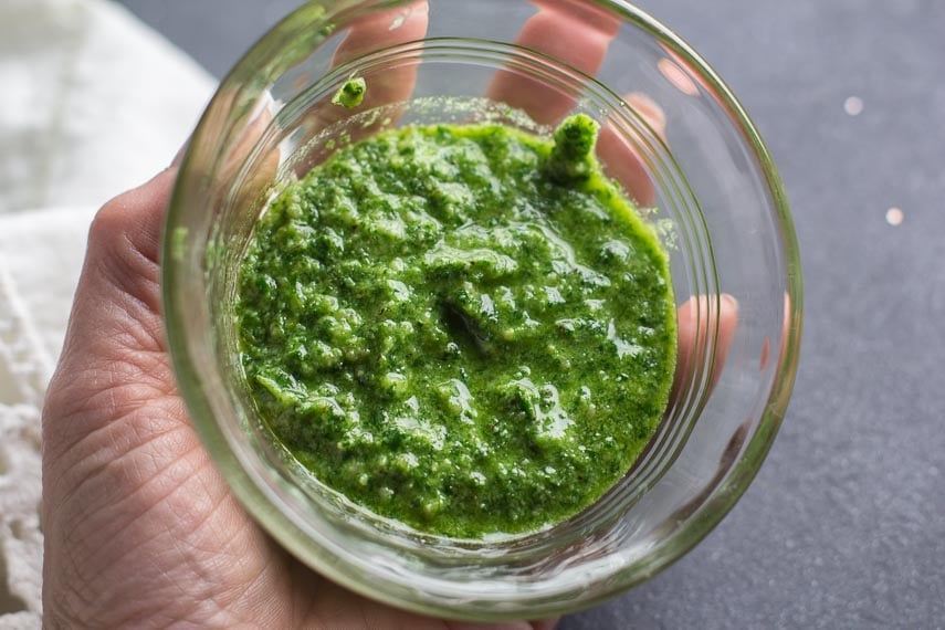 low FODMAP parsley pesto in a clear glass bowl