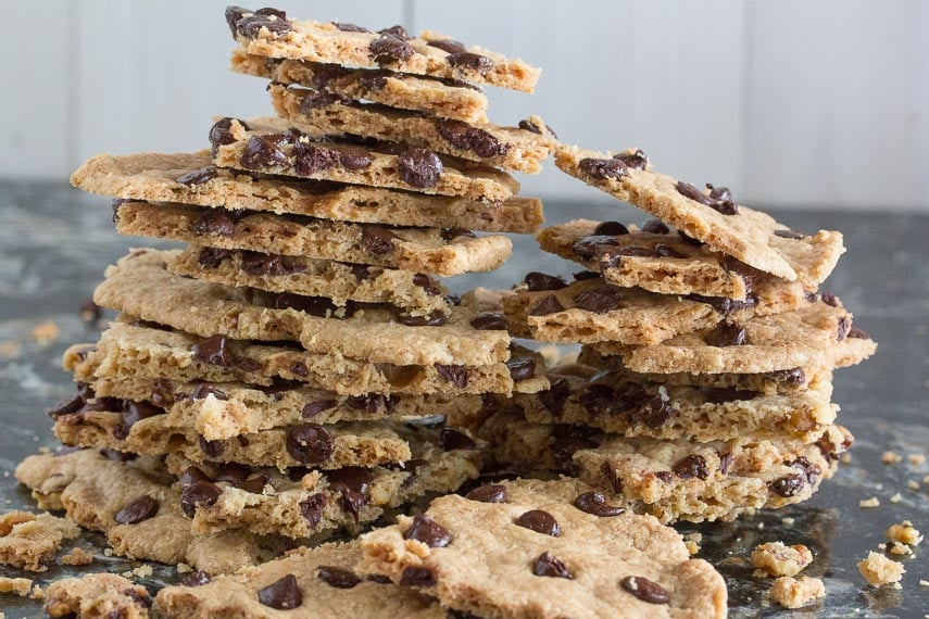 slabs of low FODMAP chocolate chip cookie brittle on a dark quartz background