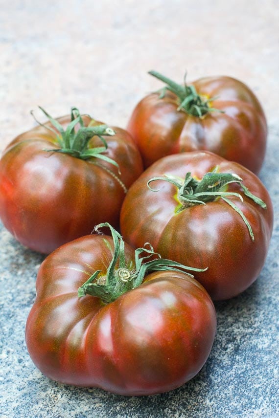 Paul Robeson tomatoes on a stone surface; use for low FODMAP gazpacho
