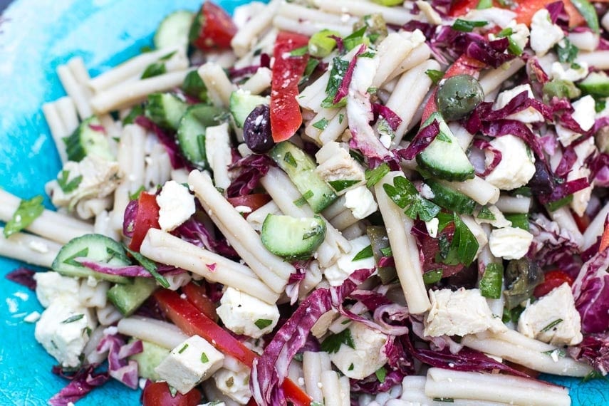 closeup of Low FODMAP Mediterranean Pasta Salad on an aqua platter