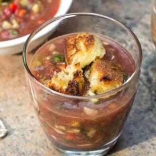 low FODMAP gazpacho in a clear glass with sourdough croutons in top