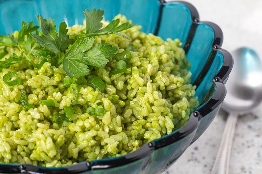 low FODMAP Cilantro Lime Rice in an aqua blue glass bowl; spoon alongside