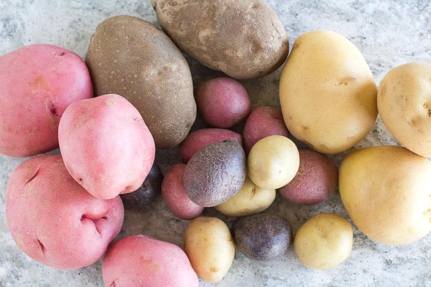 overhead view of an array of potatoes on gray quartz surface