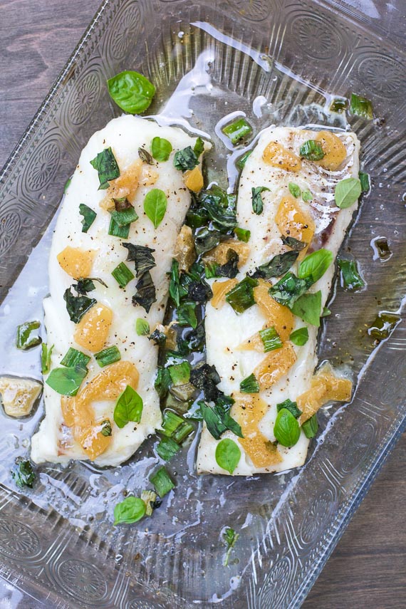 Low FODMAP cod with preserved lemons & basil in decorative glass baking dish