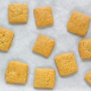 Low FODMAP Cheese Crackers on parchment lined baking sheet pan
