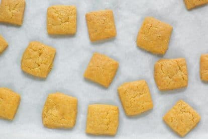 Low FODMAP Cheese Crackers on parchment lined baking sheet pan