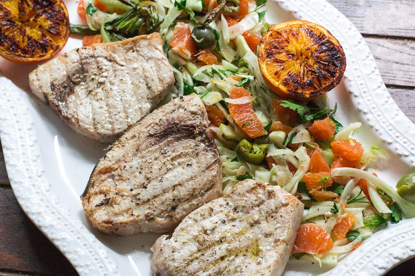 Low FODMAP Grilled Swordfish with Grilled Orange, Fennel and Green Olive Salad on a rectangular white platter