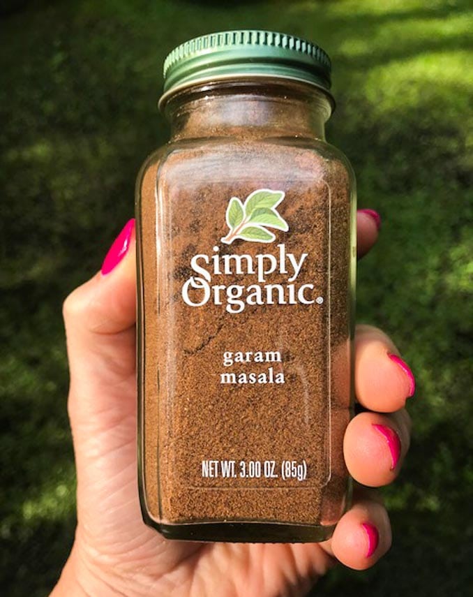 Simply Organic Garam Masala bottle held in hand