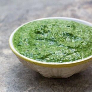 closeup chunky low FODMAP Mint Chutney in small bowl on stone surface