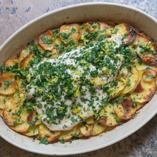 low FODMAP Bluefish with Roasted Garlic Potatoes in an oval casserole dish