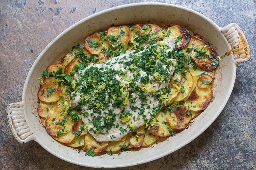 low FODMAP Bluefish with Roasted Garlic Potatoes in an oval casserole dish
