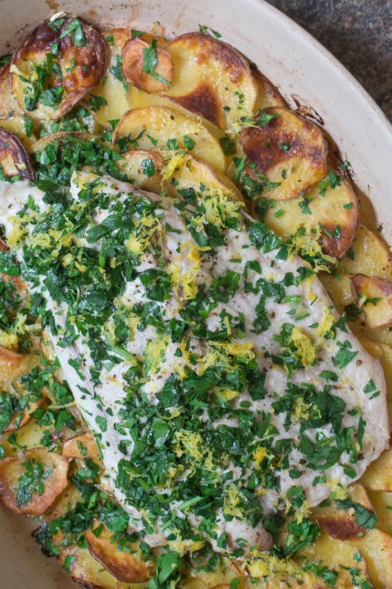 low FODMAP Bluefish with Roasted garlic Potatoes in an oval casserole; closeup