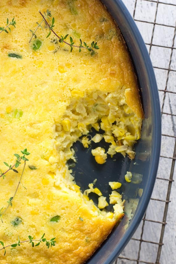 low FODMAP corn pudding in blue oval casserole dish on cooling rack