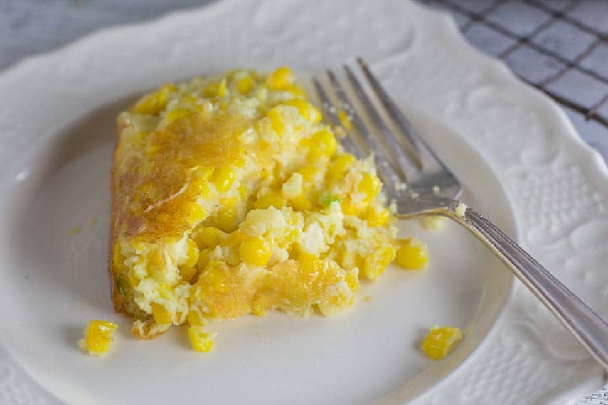 low FODMAP corn pudding serving on white plate with fork