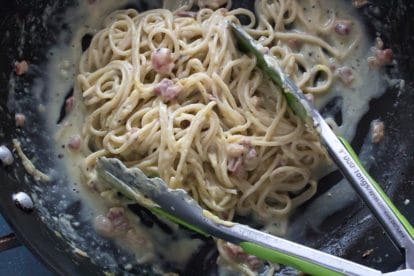 tossing lemony low FODMAP carbonara in pan