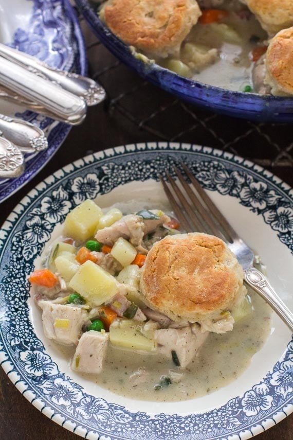 Vertical image of low FODMAP Leftover Turkey Pot Pie with Biscuit Topping on blue and white plate