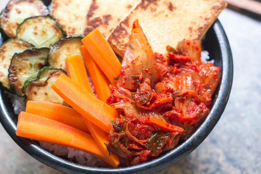 closeup of low FODMAP kimchi in bowl with tofu, carrots and zucchini