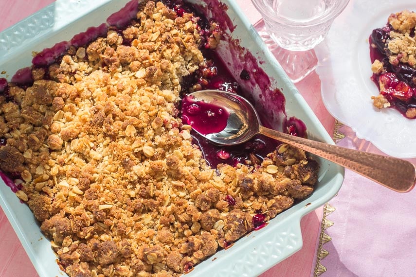 overhead of low FODMAP cranberry crisp in light blue ceramic baking dish