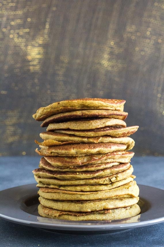 vertical image of stack of Low FODMAP Buckwheat Banana Pancakes on gray plate