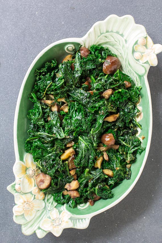 vertical overhead of Garlicky Low FODMAP Sautéed Kale with Chestnuts in oval plate