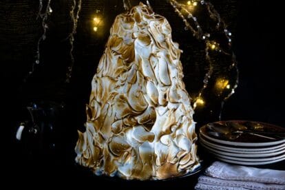Low FODMAP Baked Alaska in a tree shape against holiday lights