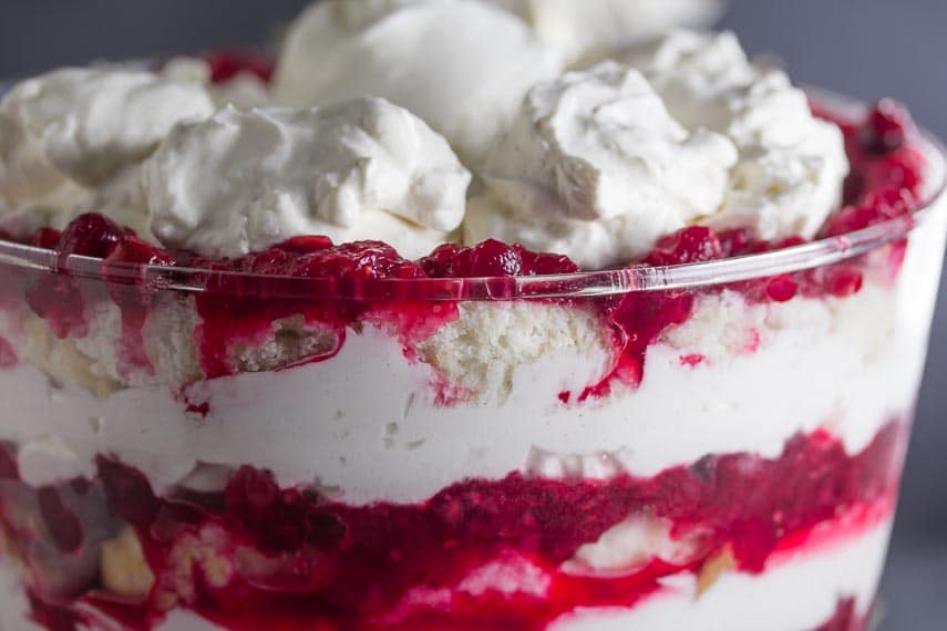 closeup of low FODMAP Cranberry Raspberry Cheesecake Trifle in trifle bowl