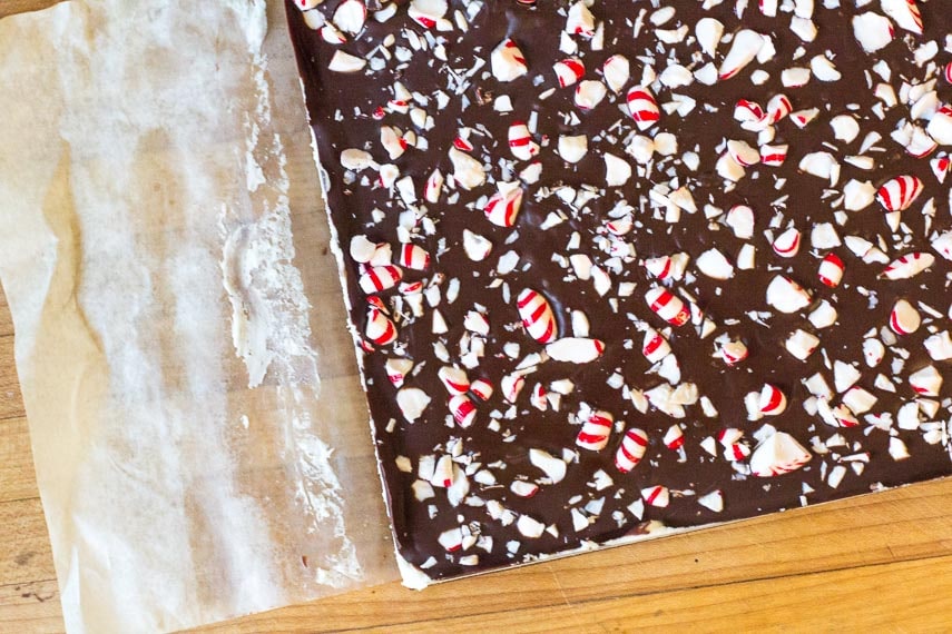 peeling away parchment paper from Low FODMAP Peppermint Brownies to make cutting easier