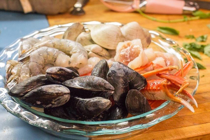 raw ingredients for Low FODMAP Cioppino in pie plate, ready to cook