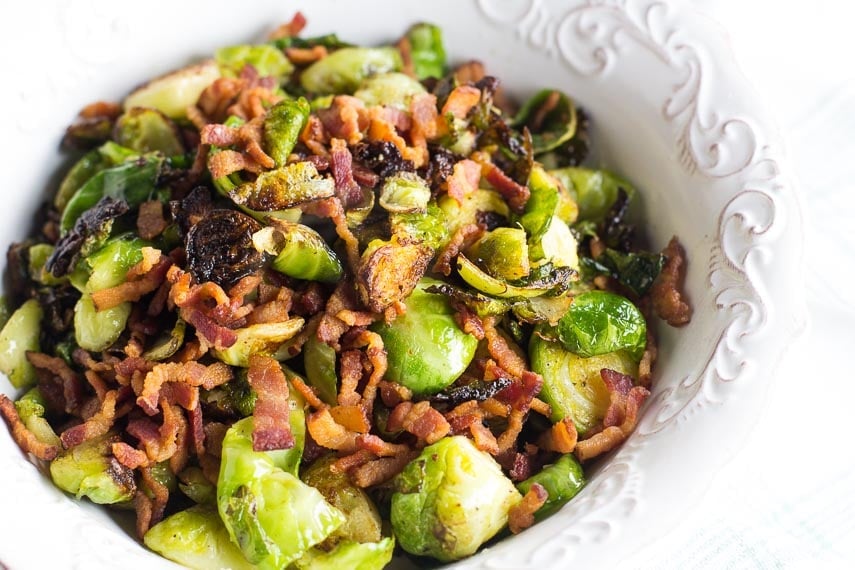 low FODMAP Brussels sprouts and bacon in white dish with raised decorative edge