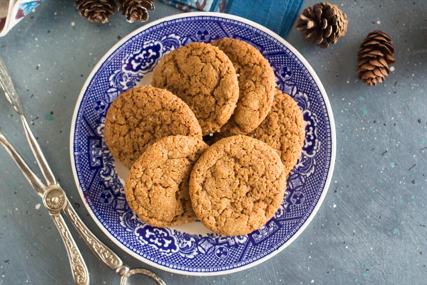 overhead image of low FODMAP gingersnaps on decorative blue plate; blue background