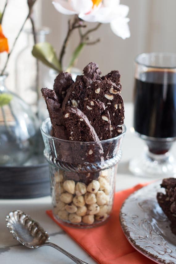 Chocolate Hazelnut Biscotti in a glass, upright. Silver spoon in front