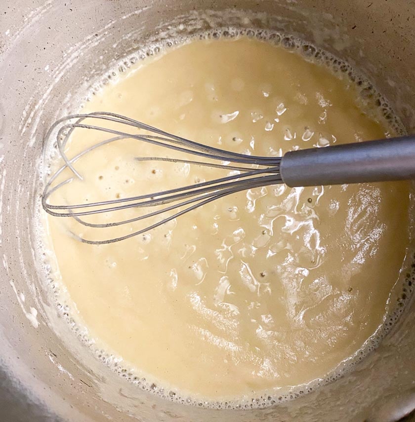 Whisking flour into butter to make a roux for low FODMAP Mac and Cheese