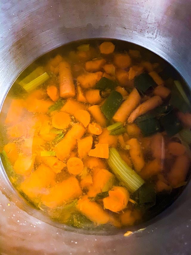 simmered carrot consommé about to be strained