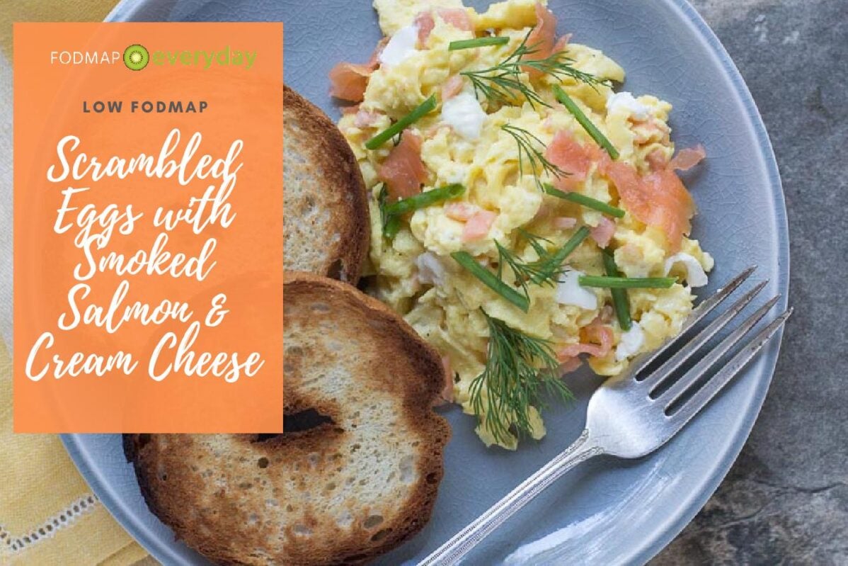 scrambled eggs with smoked salmon, cream cheese, chives nad dill on a crackled plate with toasted bagels-2