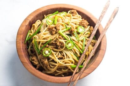 Low FODMAP Pork and Noodles in wooden bowl with chopsticks