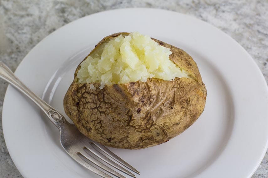 No FODMAP Baked Potato ready to eat on a white plate
