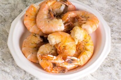 No FODMAP sauteed shrimp on white plate